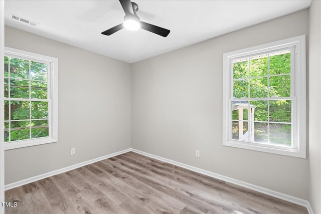 691 Oak Grove Rd, Roxboro, NC 27574 - unfurnished room featuring healthy amount of natural light, wood finished floors, and a ceiling fan