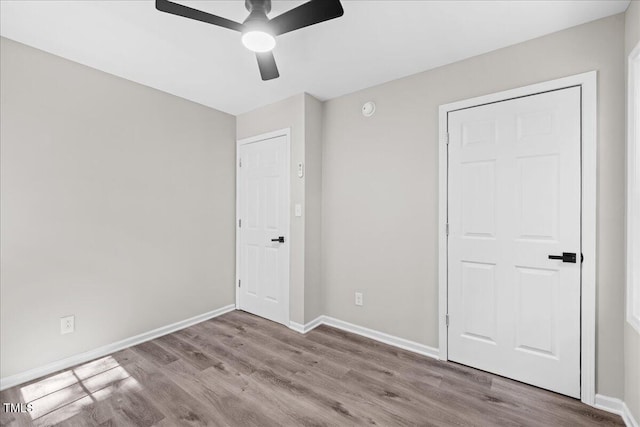 691 Oak Grove Rd, Roxboro, NC 27574 - unfurnished bedroom featuring wood finished floors and ceiling fan