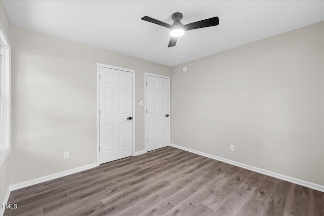 691 Oak Grove Rd, Roxboro, NC 27574 - unfurnished bedroom with wood finished floors and ceiling fan
