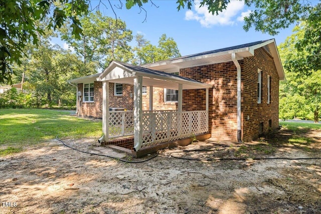 691 Oak Grove Rd, Roxboro, NC 27574 - view of side of property featuring brick siding and a yard