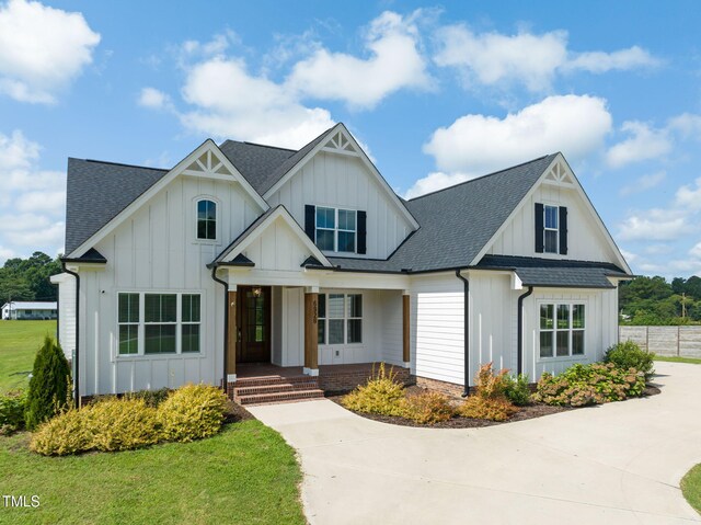 6928 Will Let Ln, Wake Forest, NC 27587 - modern inspired farmhouse with a shingled roof, board and batten siding, a porch, and concrete driveway
