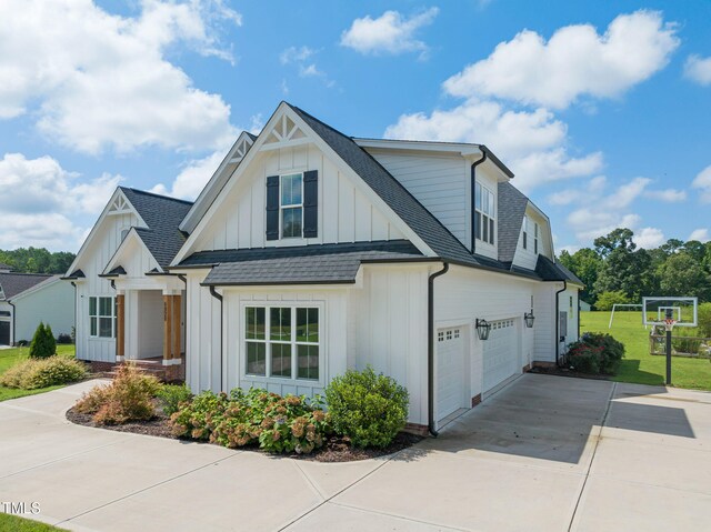 6928 Will Let Ln, Wake Forest, NC 27587 - view of front of home with board and batten siding, roof with shingles, concrete driveway, and a garage