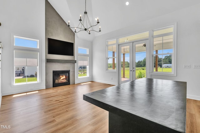6928 Will Let Ln, Wake Forest, NC 27587 - unfurnished living room with high vaulted ceiling, french doors, a chandelier, wood finished floors, and healthy amount of natural light