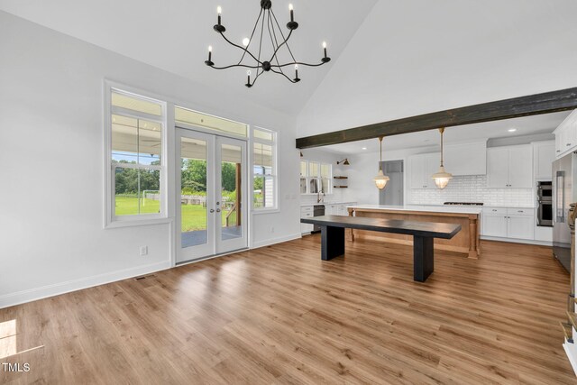 6928 Will Let Ln, Wake Forest, NC 27587 - rec room featuring french doors, a chandelier, light wood-style floors, high vaulted ceiling, and recessed lighting