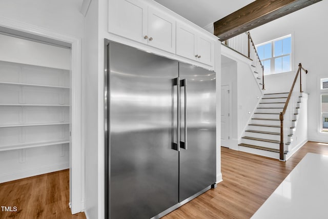 6928 Will Let Ln, Wake Forest, NC 27587 - kitchen featuring built in fridge, wood finished floors, white cabinetry, and beamed ceiling
