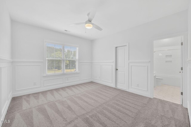 6928 Will Let Ln, Wake Forest, NC 27587 - carpeted spare room featuring a ceiling fan, a decorative wall, and a wainscoted wall