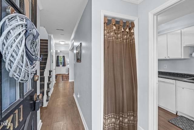 6311 New Market Way, Raleigh, NC 27615 - interior space with wood finished floors, crown molding, and stairs