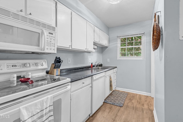 6311 New Market Way, Raleigh, NC 27615 - kitchen with white appliances, white cabinets, light wood finished floors, and dark countertops