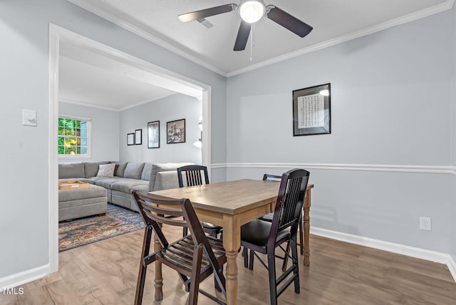 6311 New Market Way, Raleigh, NC 27615 - dining space with wood finished floors, a ceiling fan, and ornamental molding