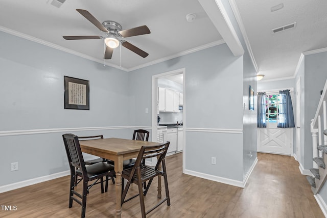 6311 New Market Way, Raleigh, NC 27615 - dining space with wood finished floors, a ceiling fan, and ornamental molding