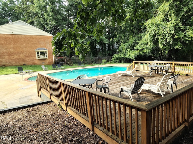 6311 New Market Way, Raleigh, NC 27615 - view of swimming pool featuring a deck, view of scattered trees, and a patio