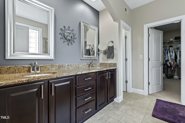 5116 Trembath Ln, Cary, NC 27519 - full bathroom with double vanity, a spacious closet, and tile patterned flooring