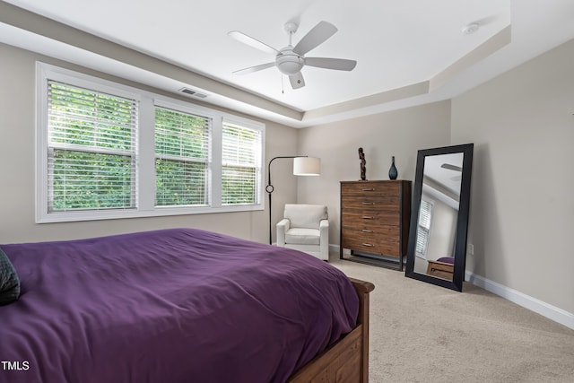 5116 Trembath Ln, Cary, NC 27519 - bedroom with light carpet, a tray ceiling, and ceiling fan