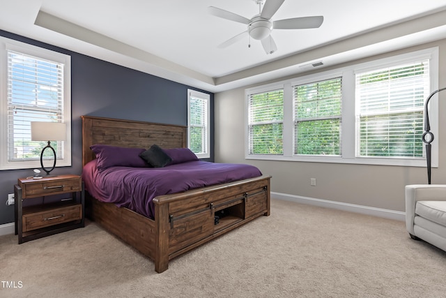 5116 Trembath Ln, Cary, NC 27519 - bedroom with light colored carpet, a ceiling fan, and a raised ceiling