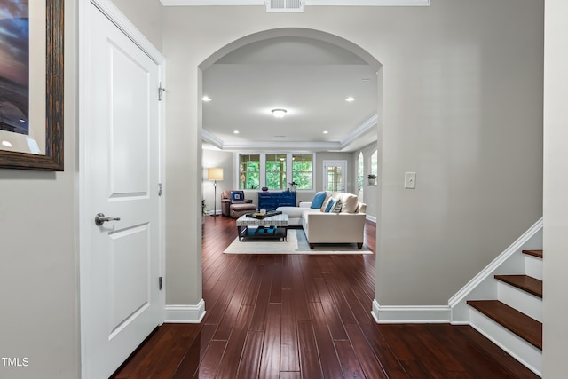 5116 Trembath Ln, Cary, NC 27519 - hallway featuring arched walkways, dark wood-style flooring, ornamental molding, and stairs
