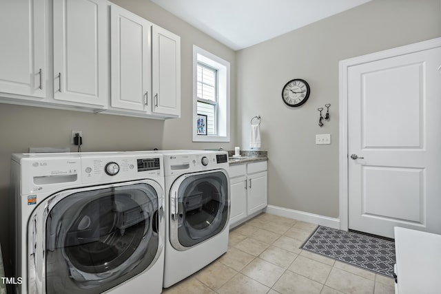 5116 Trembath Ln, Cary, NC 27519 - washroom featuring washing machine and dryer, cabinet space, and light tile patterned floors