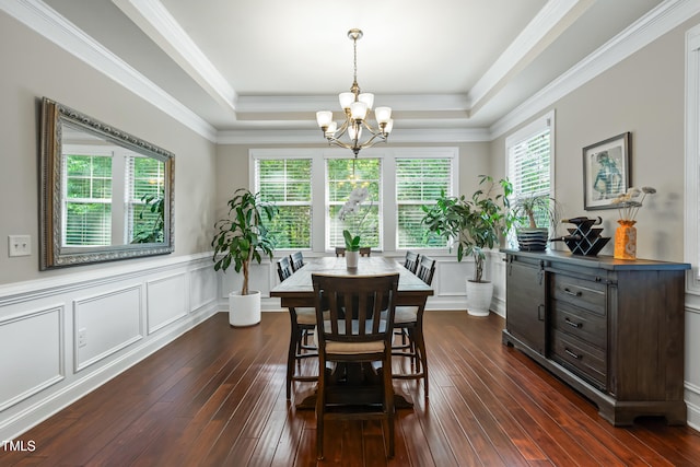 5116 Trembath Ln, Cary, NC 27519 - dining area featuring a chandelier, a tray ceiling, dark wood-style flooring, wainscoting, and crown molding