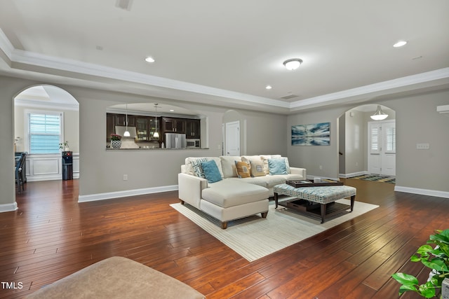 5116 Trembath Ln, Cary, NC 27519 - living area featuring arched walkways, a tray ceiling, crown molding, dark wood finished floors, and recessed lighting