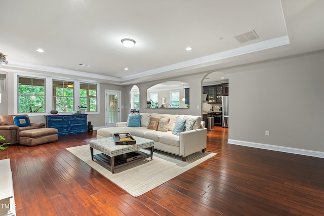 5116 Trembath Ln, Cary, NC 27519 - living area with arched walkways, a tray ceiling, hardwood / wood-style flooring, crown molding, and recessed lighting
