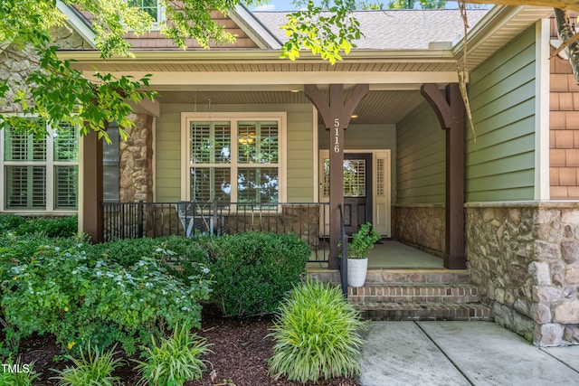 5116 Trembath Ln, Cary, NC 27519 - doorway to property featuring stone siding and covered porch