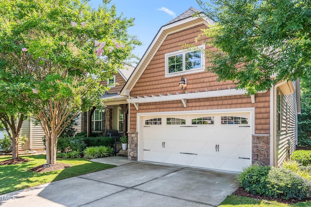 5116 Trembath Ln, Cary, NC 27519 - view of front of house with stone siding, driveway, and a garage