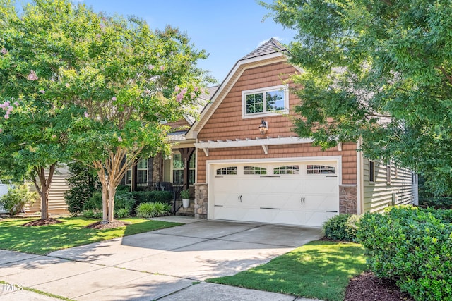 5116 Trembath Ln, Cary, NC 27519 - view of front of property with stone siding, a garage, driveway, and a front yard