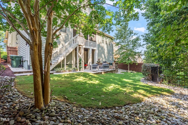 5116 Trembath Ln, Cary, NC 27519 - fenced backyard featuring stairway, a wooden deck, and a patio area
