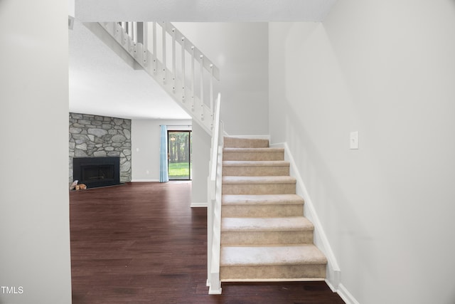 122 Woodbridge Ln, Chapel Hill, NC 27514 - stairs with wood finished floors and a fireplace