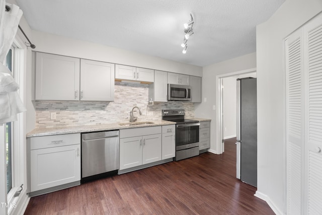 122 Woodbridge Ln, Chapel Hill, NC 27514 - kitchen with appliances with stainless steel finishes, tasteful backsplash, dark wood-style flooring, light stone countertops, and a textured ceiling