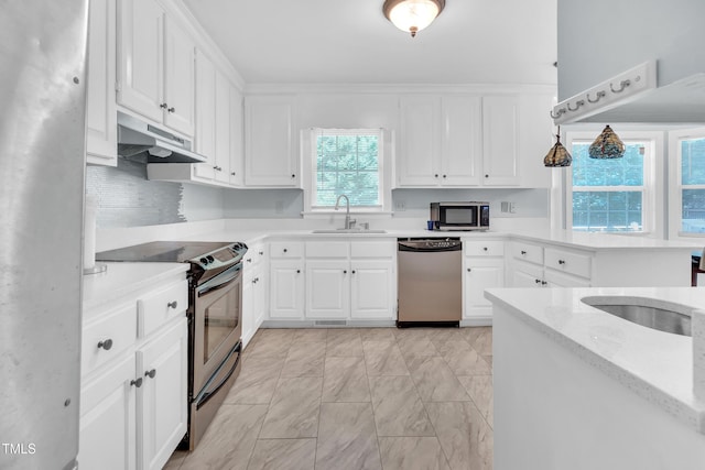1200 Cambridge Rd NW, Wilson, NC 27896 - kitchen featuring stainless steel appliances, under cabinet range hood, a peninsula, and white cabinetry