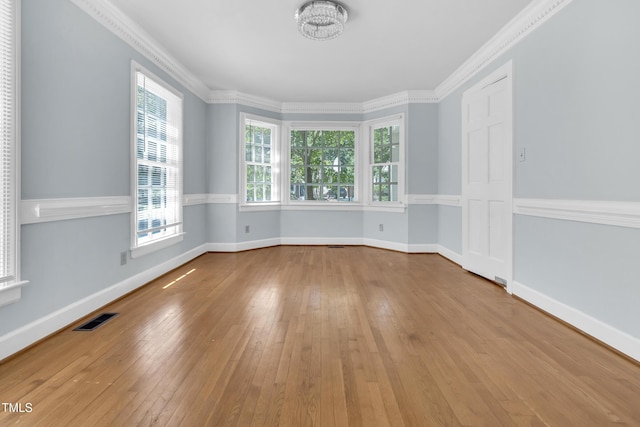 1200 Cambridge Rd NW, Wilson, NC 27896 - unfurnished room with wood-type flooring, a chandelier, and crown molding