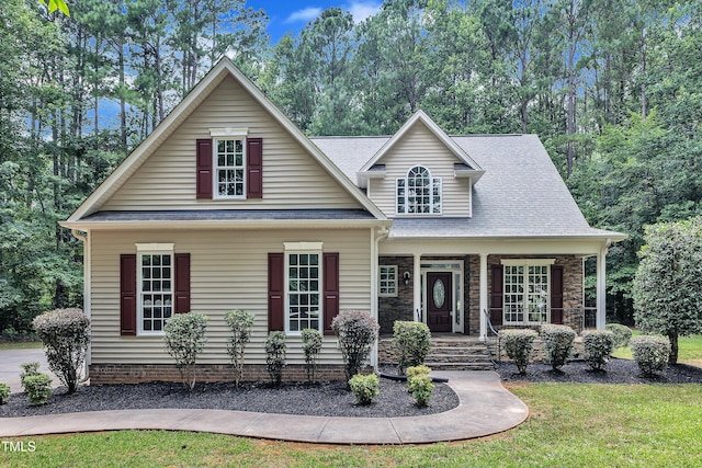 2103 Troys Trl, Franklinton, NC 27525 - view of front of house featuring covered porch, roof with shingles, a front lawn, and view of wooded area