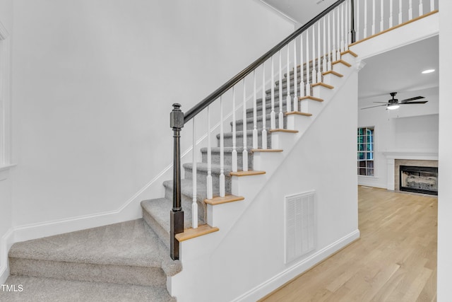 2103 Troys Trl, Franklinton, NC 27525 - stairs with wood finished floors, ceiling fan, a tile fireplace, a high ceiling, and recessed lighting