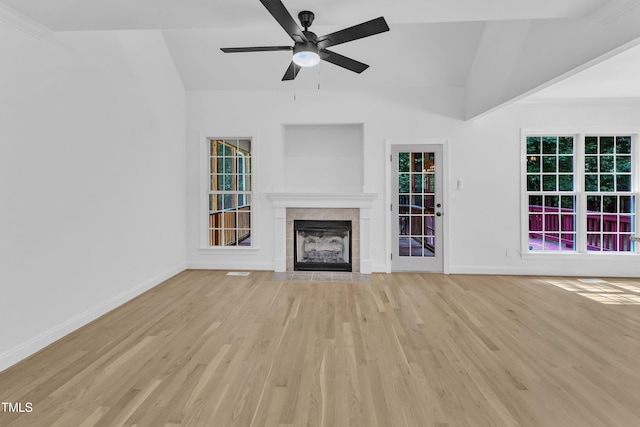 2103 Troys Trl, Franklinton, NC 27525 - unfurnished living room featuring lofted ceiling, a tiled fireplace, light wood-type flooring, and a ceiling fan