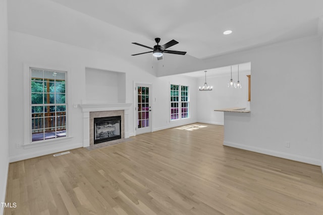 2103 Troys Trl, Franklinton, NC 27525 - unfurnished living room with a chandelier, a tiled fireplace, ceiling fan, light wood-style floors, and recessed lighting