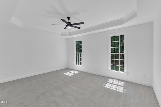 2103 Troys Trl, Franklinton, NC 27525 - carpeted empty room featuring a tray ceiling, ornamental molding, healthy amount of natural light, and a ceiling fan