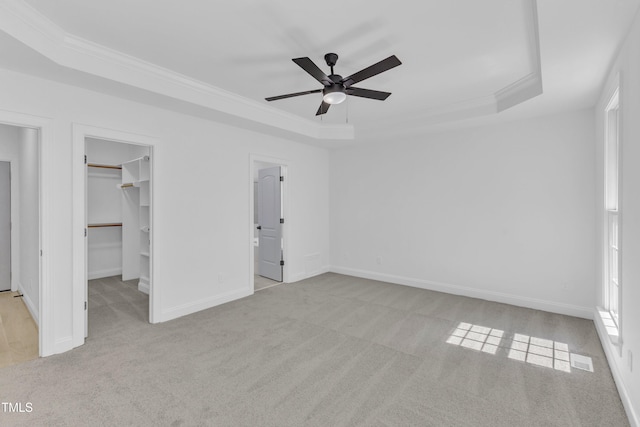 2103 Troys Trl, Franklinton, NC 27525 - unfurnished bedroom with a raised ceiling, carpet, crown molding, a walk in closet, and ceiling fan