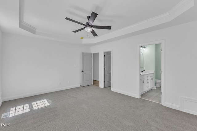 2103 Troys Trl, Franklinton, NC 27525 - unfurnished bedroom with a raised ceiling, crown molding, light colored carpet, connected bathroom, and a ceiling fan