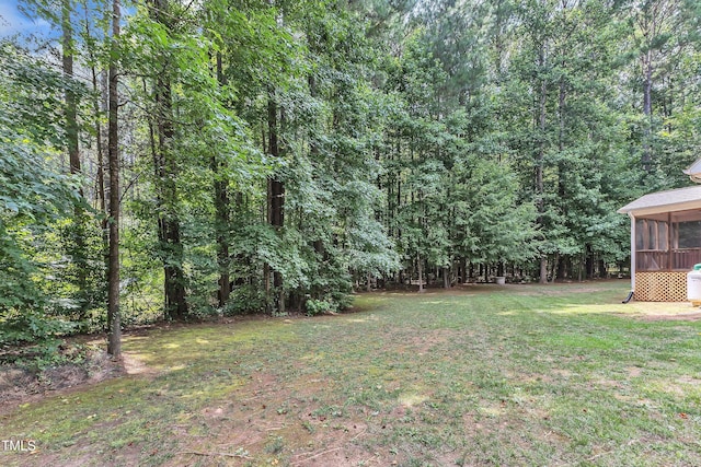 2103 Troys Trl, Franklinton, NC 27525 - view of green lawn featuring a sunroom and a forest view