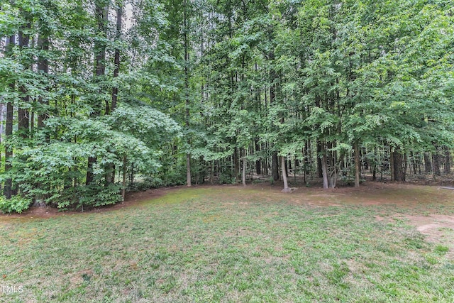 2103 Troys Trl, Franklinton, NC 27525 - view of grassy yard featuring a forest view
