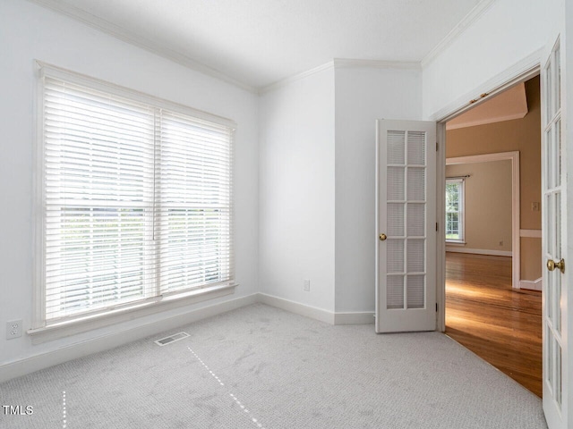 103 Glenstone Ln, Cary, NC 27518 - spare room featuring crown molding, french doors, and carpet floors