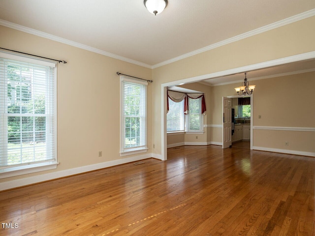 103 Glenstone Ln, Cary, NC 27518 - unfurnished room featuring a chandelier, wood finished floors, and crown molding