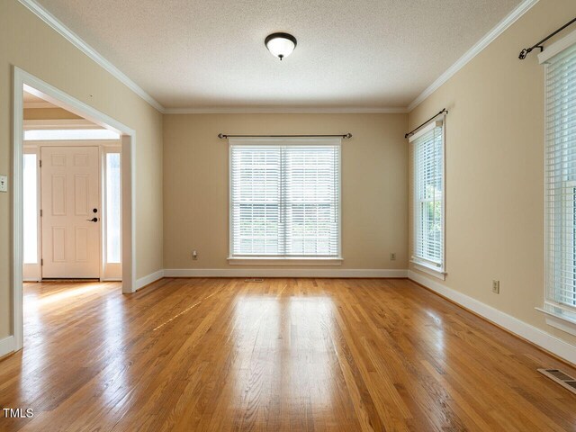 103 Glenstone Ln, Cary, NC 27518 - empty room featuring wood finished floors, a textured ceiling, and ornamental molding