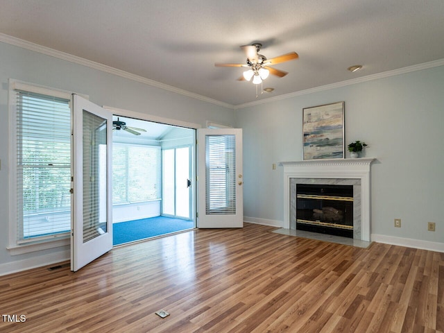 103 Glenstone Ln, Cary, NC 27518 - unfurnished living room featuring a ceiling fan, wood finished floors, crown molding, and a high end fireplace