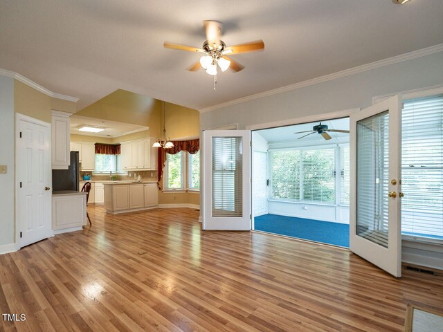 103 Glenstone Ln, Cary, NC 27518 - unfurnished living room with a ceiling fan, light wood-type flooring, and crown molding