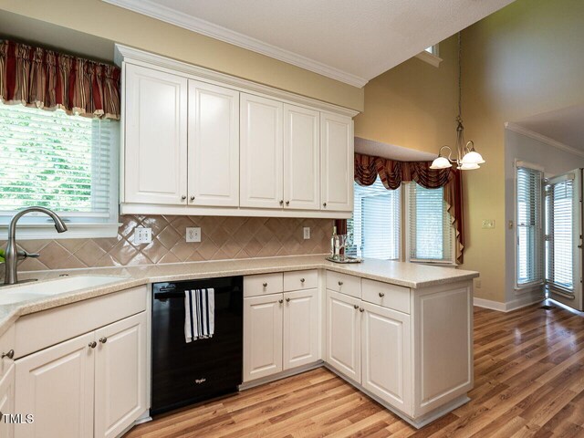103 Glenstone Ln, Cary, NC 27518 - kitchen with dishwasher, crown molding, light wood-type flooring, and tasteful backsplash