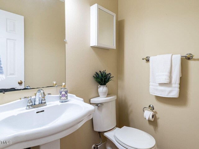 103 Glenstone Ln, Cary, NC 27518 - half bathroom featuring a sink and toilet