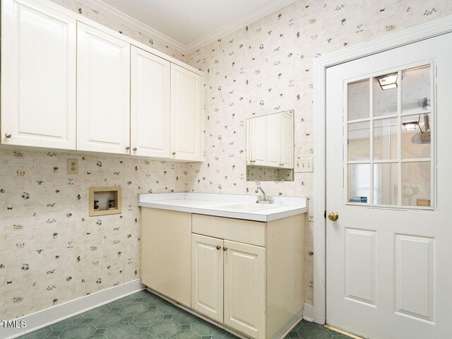 103 Glenstone Ln, Cary, NC 27518 - laundry area featuring hookup for a washing machine, wallpapered walls, cabinet space, ornamental molding, and dark tile patterned floors