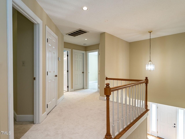 103 Glenstone Ln, Cary, NC 27518 - hall with an upstairs landing, light colored carpet, and recessed lighting