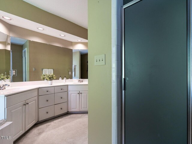 103 Glenstone Ln, Cary, NC 27518 - full bathroom featuring double vanity, a shower stall, and recessed lighting
